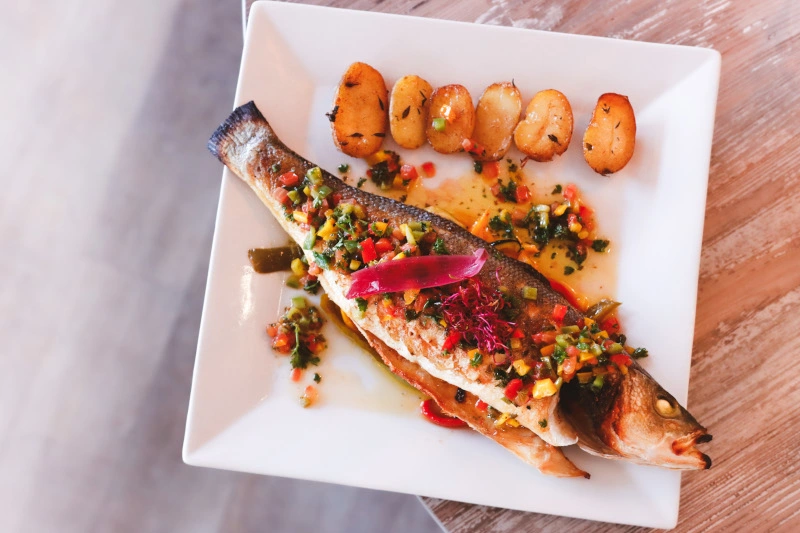 Grilled whole fish image with jacket potatoes